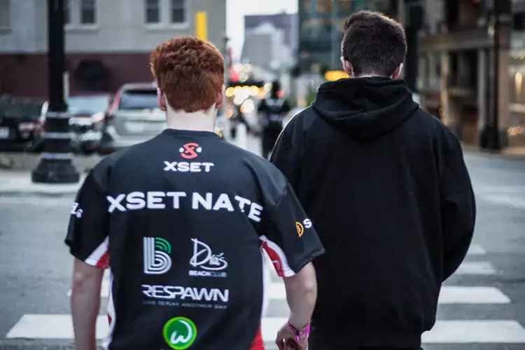 Image of Nate Schanker wearing an XSET jersey while crossing a cross walk.